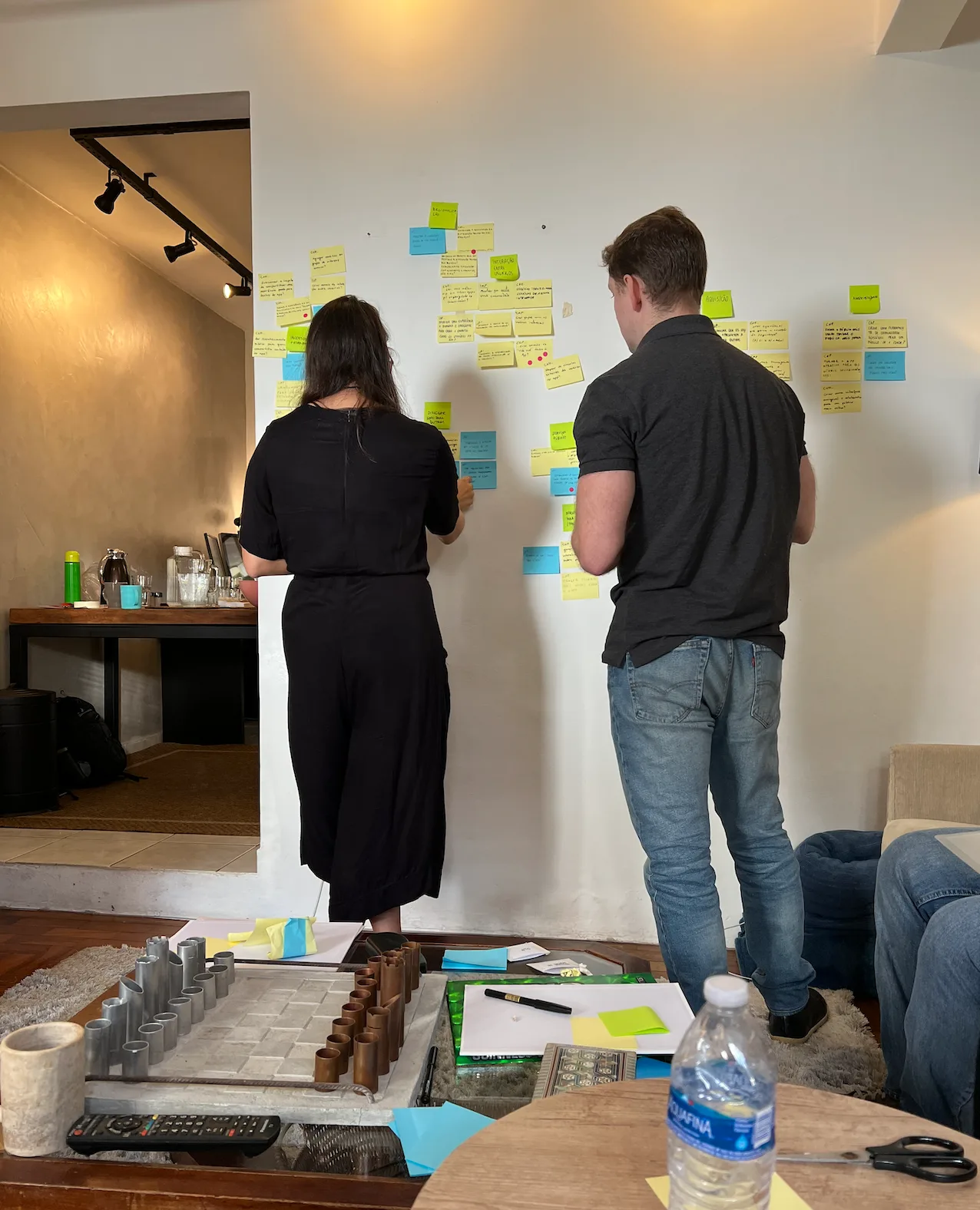 How Might We notes clustered on the wall